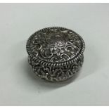 A silver embossed top box with hinged decoration.