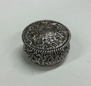 A silver embossed top box with hinged decoration.