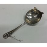 An Edwardian silver tea strainer with pierced hand