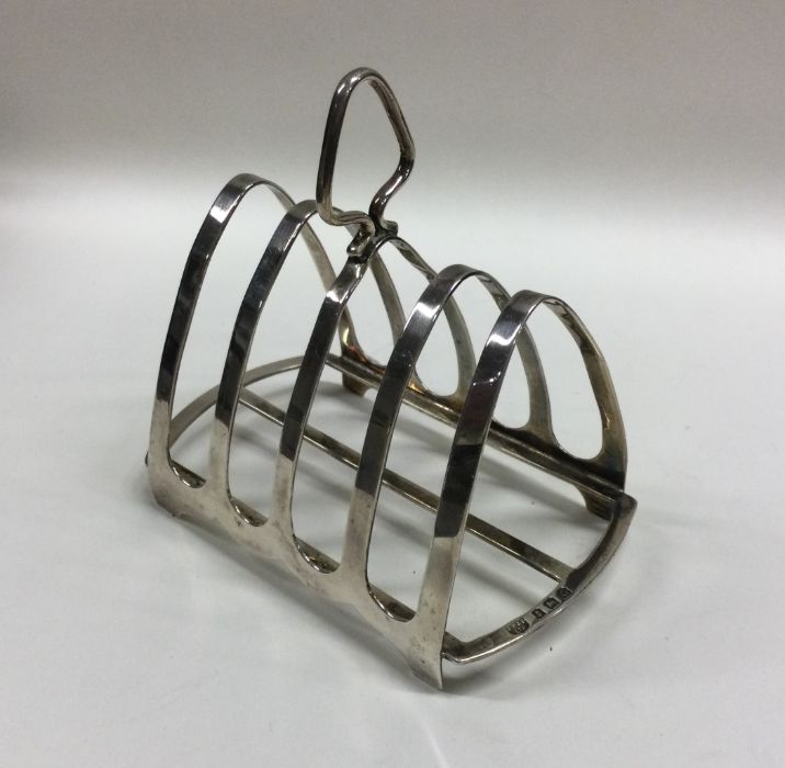 A heavy silver five bar toast rack on bracket feet