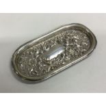 A heavy chased silver bonbon dish decorated with f