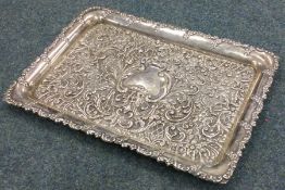 A massive embossed silver dressing table tray deco