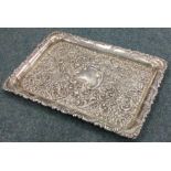 A massive embossed silver dressing table tray deco
