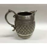 A heavy barrel shaped Indian Colonial silver jug.