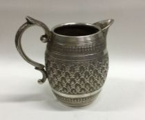 A heavy barrel shaped Indian Colonial silver jug.