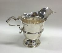 A Georgian style cast silver cream jug of Irish de