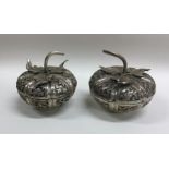 A pair of chased Chinese silver pots and covers of