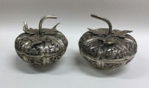 A pair of chased Chinese silver pots and covers of