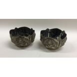 A pair of heavy Indian silver bowls with shaped ri