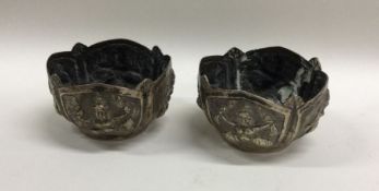 A pair of heavy Indian silver bowls with shaped ri