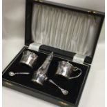 A stylish silver three piece cruet set attractivel