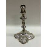 A heavy cast Victorian silver taper stick of typic