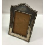 A rectangular dome top picture frame with beaded r