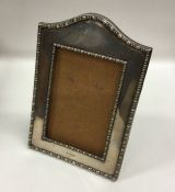 A rectangular dome top picture frame with beaded r