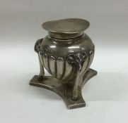 A rare silver hinged top inkwell on shaped base. L