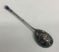 A heavy Russian silver and enamelled spoon attract