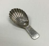 A George III silver caddy spoon with fluted bowl.