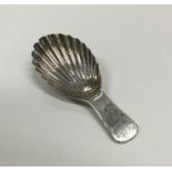 A George III silver caddy spoon with fluted bowl.