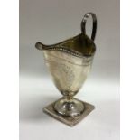 A heavy Georgian silver bright cut cream jug with
