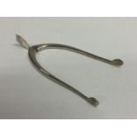 A pair of heavy silver wishbone sugar tongs. Birmi