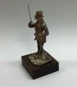 A small silver figure of a man with gun entitled,