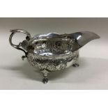 A heavy Georgian chased silver sauce boat decorate