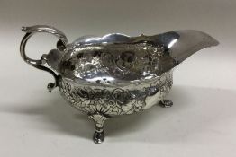 A heavy Georgian chased silver sauce boat decorate