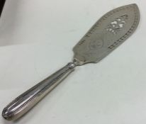 A heavy pierced silver slice decorated with scroll