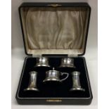 A good cased silver and Bakelite five piece cruet