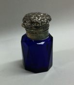 A blue glass silver mounted scent bottle with embo