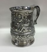 A heavy chased Georgian silver tankard decorated w