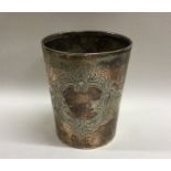 A large tapering silver beaker with scroll decorat