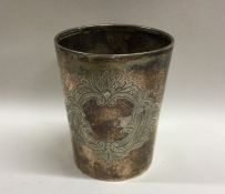 A large tapering silver beaker with scroll decorat