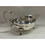 A Georgian silver sauce boat with card cut rim on