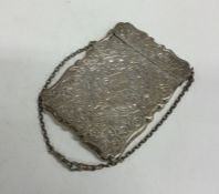 A slim Victorian silver card case with hinged top.