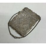 A slim Victorian silver card case with hinged top.