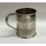 A Georgian silver tapering cup of reeded form. App