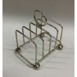 A small silver five bar toast rack on ball feet. S