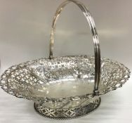 A large Georgian silver sugar basket with swing ha