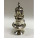 A heavy Edwardian silver caster on spreading base.