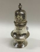 A heavy Edwardian silver caster on spreading base.