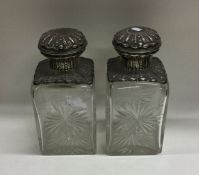 A pair of large rectangular silver topped scent bo