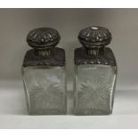 A pair of large rectangular silver topped scent bo