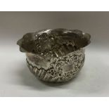 A silver half fluted sugar bowl with shaped rim. L