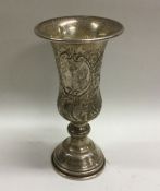 A large silver embossed Kiddush cup decorated with