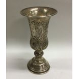 A large silver embossed Kiddush cup decorated with