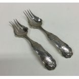 A pair of attractive Dutch silver forks with scrol