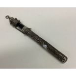 An unusual silver embossed pen holder with suspens