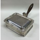 A small silver hinged top entrée dish with shell h