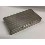 An engine turned silver cigarette case with hinged